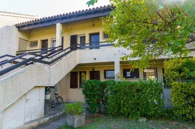 a building with a staircase in front of it at A nostra casetta corsa,Tania, en bord de mer in Ghisonaccia
