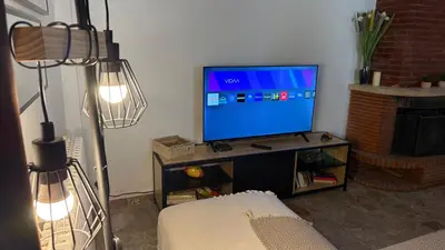a living room with a flat screen tv on a table at Mare è Muntagna in Mignataja