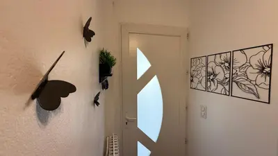 a hallway with a door with birds on the wall at Mare è Muntagna in Mignataja