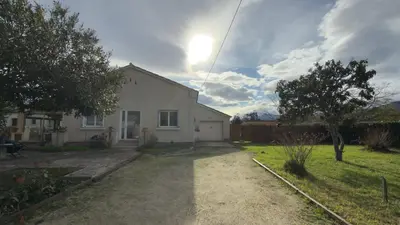 a white house with the sun in the sky at Mare è Muntagna in Mignataja