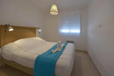a bedroom with a bed with a stuffed animal on it at Corsica Beach, Paddleboarding, Pool & Hiking J159 in Linguizzetta