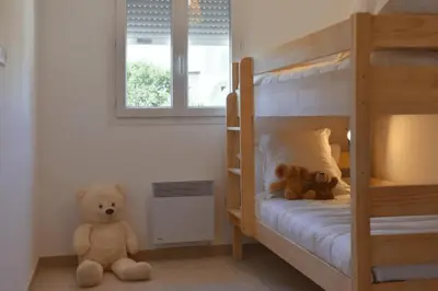 two teddy bears sitting on the floor in a bedroom at Corsica Beach, Paddleboarding, Pool & Hiking J159 in Linguizzetta