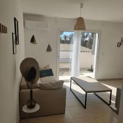 a living room with a couch and a table at Corsica Beach, Paddleboarding, Pool & Hiking J159 in Linguizzetta