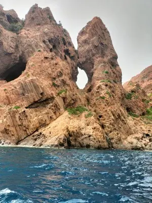 a rocky island in the water near the ocean at Petit cocon près des Calanques de Piana in Porto Ota