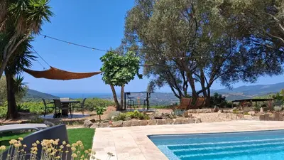 a villa with a swimming pool and a view at A Casa Faggia in Sollacaro