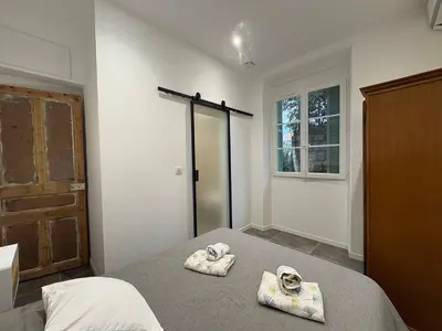 a bedroom with a bed with two towels on it at Appartement plein centre avec jardin de 40m2 près des plages in Propriano