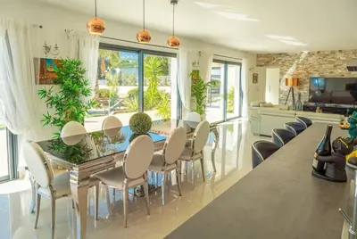 a kitchen and dining room with a table and chairs at Villa Suartello Porto Vecchio avec piscine privée in Porto-Vecchio
