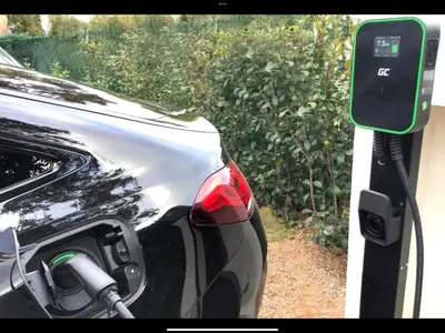 a car is parked next to a solar car charger at Villa Suartello Porto Vecchio avec piscine privée in Porto-Vecchio