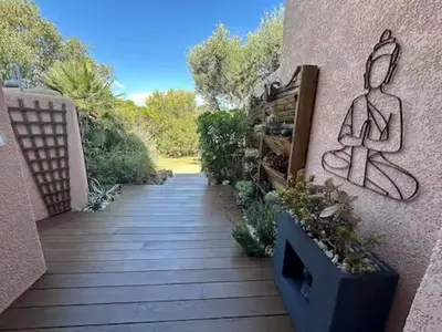 a walkway with a painting on the side of a building at Mini Villa Kallisté - vue mer exceptionnelle sur la baie de Palombaggia in Porto-Vecchio
