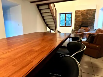 a long wooden table in a room with chairs at Appartement charmant - Entre campagne et ville in Corte