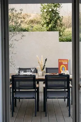 a dining table with two chairs and a table and chairsearcher at Résidence A Stella in Piana