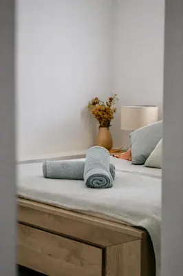 a bed with a towel sitting on top of it at Résidence A Stella in Piana