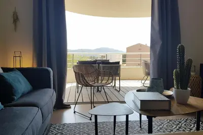 a living room with a couch and a table at Beautiful modern 4-star apartment with swimming pool and Wi-Fi in Porto-Vecchio