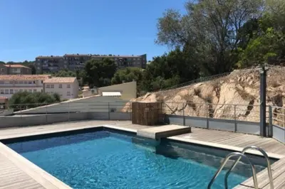a swimming pool on top of a building at Beautiful modern 4-star apartment with swimming pool and Wi-Fi in Porto-Vecchio