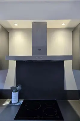 a kitchen with a black stove top oven at Bas de villa 27 Pietrosella in Pietrosella