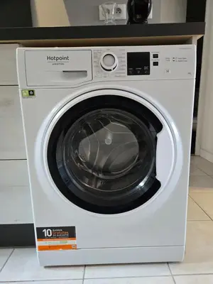 a white washing machine sitting in a kitchen at Bas de villa 27 Pietrosella in Pietrosella