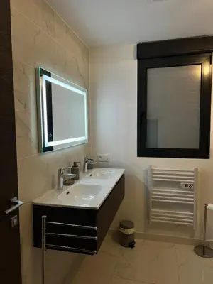 a bathroom with a sink and a mirror at Résidence Les Jardins du Piale in Bonifacio
