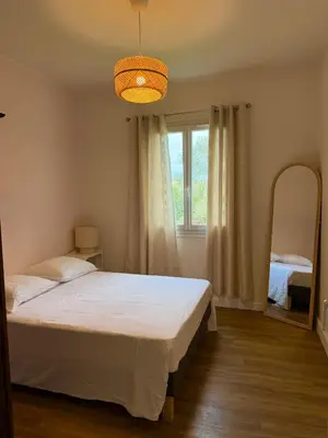 a bedroom with a bed and a large window at Villa San Michele 3 chambres in Linguizzetta