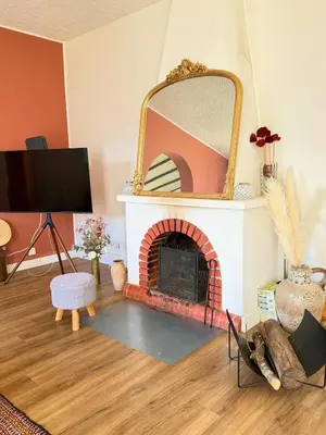 a living room with a fireplace and a mirror at Villa San Michele 3 chambres in Linguizzetta