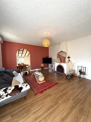 a living room with a bed and a fireplace at Villa San Michele 3 chambres in Linguizzetta