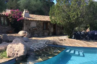 a house with a swimming pool in a yard at Charming villa # Petra's House in Palombaggia in Porto-Vecchio