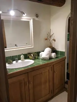 a bathroom with a sink and a mirror at Charming villa # Petra's House in Palombaggia in Porto-Vecchio