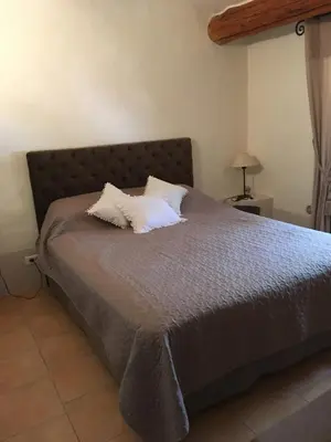 a bed with two pillows on it in a bedroom at Charming villa # Petra's House in Palombaggia in Porto-Vecchio
