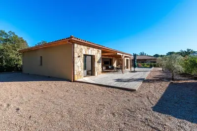 a small house with a patio in a yard at Villa U Capu - Piscine Privée in Lecci