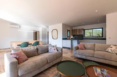 a living room with two couches and a table at Villa U Capu - Piscine Privée in Lecci