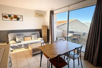a living room with a table and a couch at Appartement 4 personnes - Soléa 137 - Vue Mer in Serra-di-Ferro