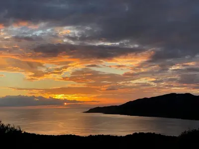 a sunset over a body of water with a mountain at Appartement 4 personnes - Soléa 137 - Vue Mer in Serra-di-Ferro