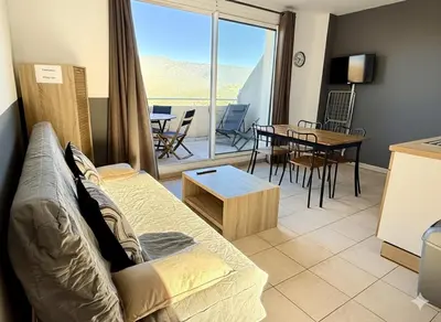 a living room with a couch and a table at Appartement 4 personnes - Soléa 137 - Vue Mer in Serra-di-Ferro