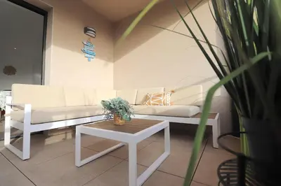 a living room with two white couches and a table at L'ÉCRIN - T2 65 m2 - Terrasse vue Mer & Maquis - Agosta plage à 200m- Parking privé in Albitreccia