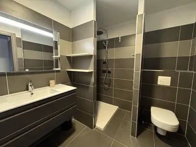 a bathroom with a sink and a toilet and a shower at 2 pièces au cœur de la ville de Propriano in Propriano