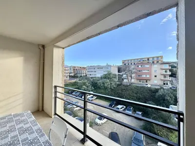 a balcony with a view of a parking lot at 2 pièces au cœur de la ville de Propriano in Propriano