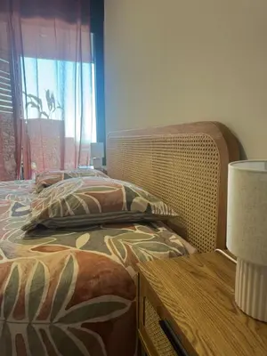 a bedroom with a bed and a table and a window at Appartement vue mer et montagne in Olmeta-di-Tuda