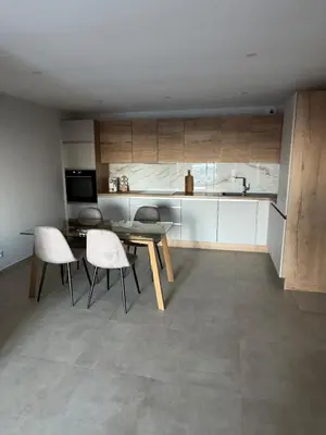 a kitchen with a table and chairs in a room at Appartement vue mer et montagne in Olmeta-di-Tuda
