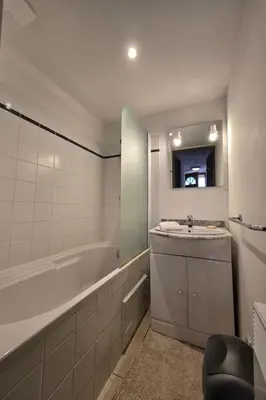 a bathroom with a sink and a bath tub at Mini villa vue jardin dans résidence calme wifi piscine mer à pied in Serra-di-Ferro