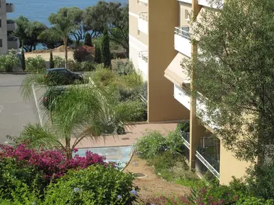 a view of a building with plants and flowers at Appartement 3 étoiles près des plages d'Ajaccio in Ajaccio