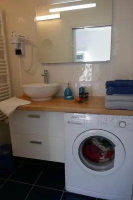a bathroom with a washing machine and a sink at Appartement 3 étoiles près des plages d'Ajaccio in Ajaccio