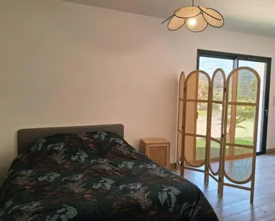 a bedroom with a bed and a window at Lumineux studio entre terre et mer à 2min de la plage in Calcatoggio