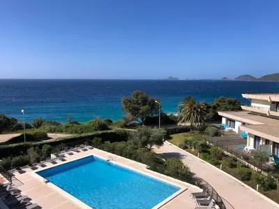 a swimming pool with the ocean in the background at Ajaccio Sanguinaires - 3p - Terrasse - Piscine in Ajaccio