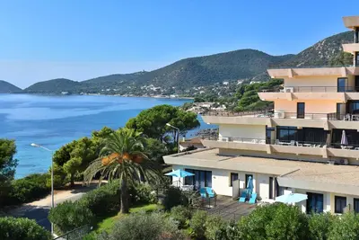 a view of a building and the ocean at Ajaccio Sanguinaires - 3p - Terrasse - Piscine in Ajaccio