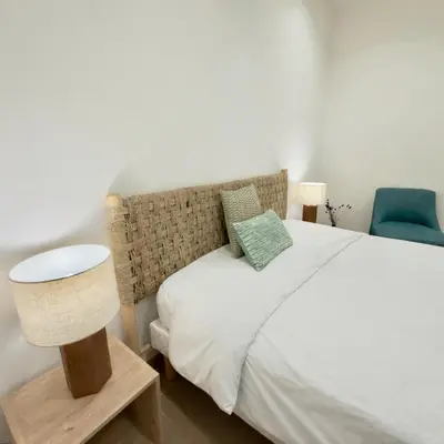 a living room with a couch and a table at Deux pièces tout confort vue mer imprenable in Propriano