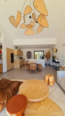 a living room with a couch and a table at Charming setting with private pool in Cala Rossa in Lecci