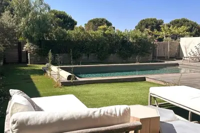a backyard with a swimming pool and some chairs at Charming setting with private pool in Cala Rossa in Lecci