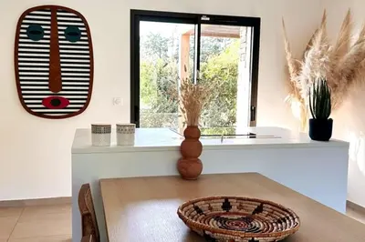 a dining room with a table and a window at Charming setting with private pool in Cala Rossa in Lecci