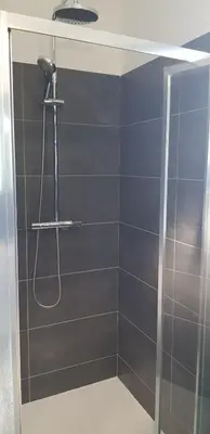 a bathroom with a shower with a glass door at Godichard Apartment in a residence for 46 people with swimming pool and in Porto-Vecchio