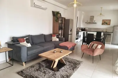 a living room with a couch and a table at Godichard Apartment in a residence for 46 people with swimming pool and in Porto-Vecchio
