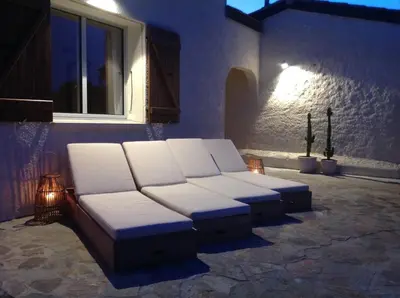 a room with a couch and a window at night at Villa Golfe Favone Corsica 10P Pool Sea View in Sari Solenzara